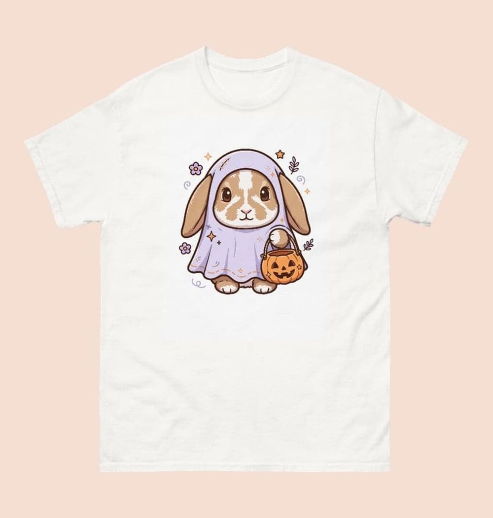 A friendly Halloween illustration of the pet in a loose ghost costume with their face and ears visible, holding a tiny pumpkin bucket, on a t-shirt (example made with AI)