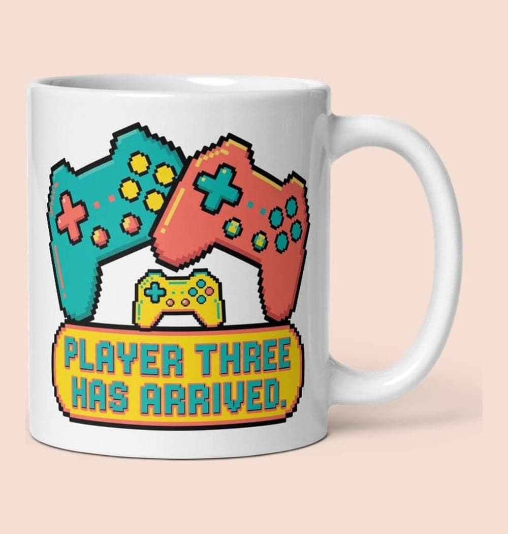 A cheerful original game-inspired emblem with two large controllers and one tiny controller between them, on a mug (example made with AI)