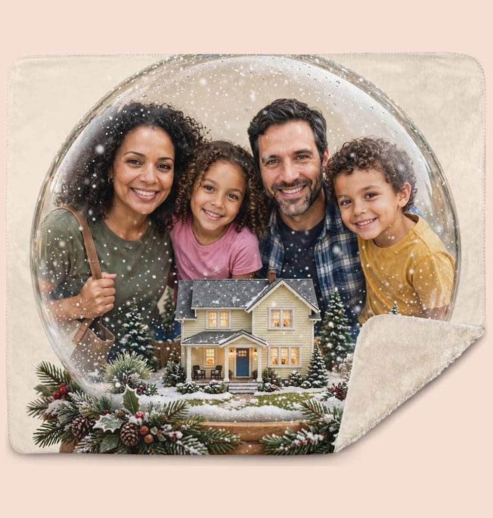 The family inside a beautifully illustrated snow globe with a miniature version of the home and gentle falling snow, on a blanket (example made with AI)