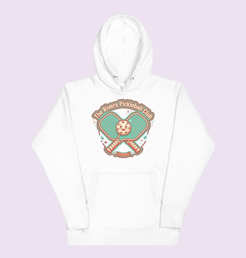 A playful original badge with two crossed paddles, a smiling ball, and the supplied club or household name, on a hoodie (example made with AI)