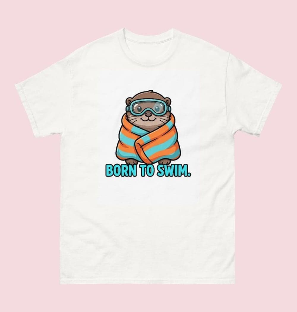 A cheerful original otter wearing swimming goggles and wrapped in an oversized towel, on a t-shirt (example made with AI)