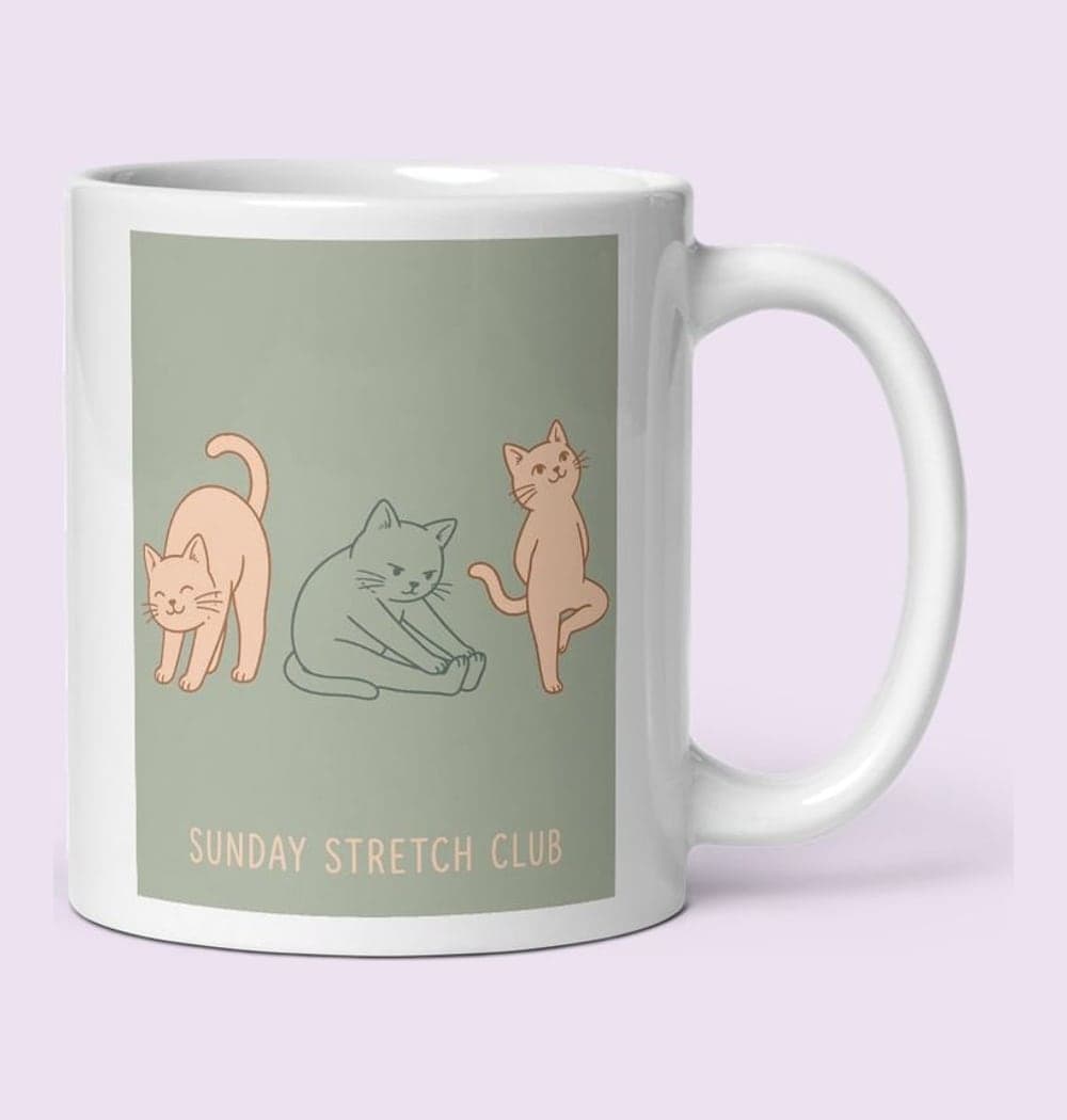 A row of three friendly original cats attempting different yoga stretches, each with a distinct expression, on a mug (example made with AI)