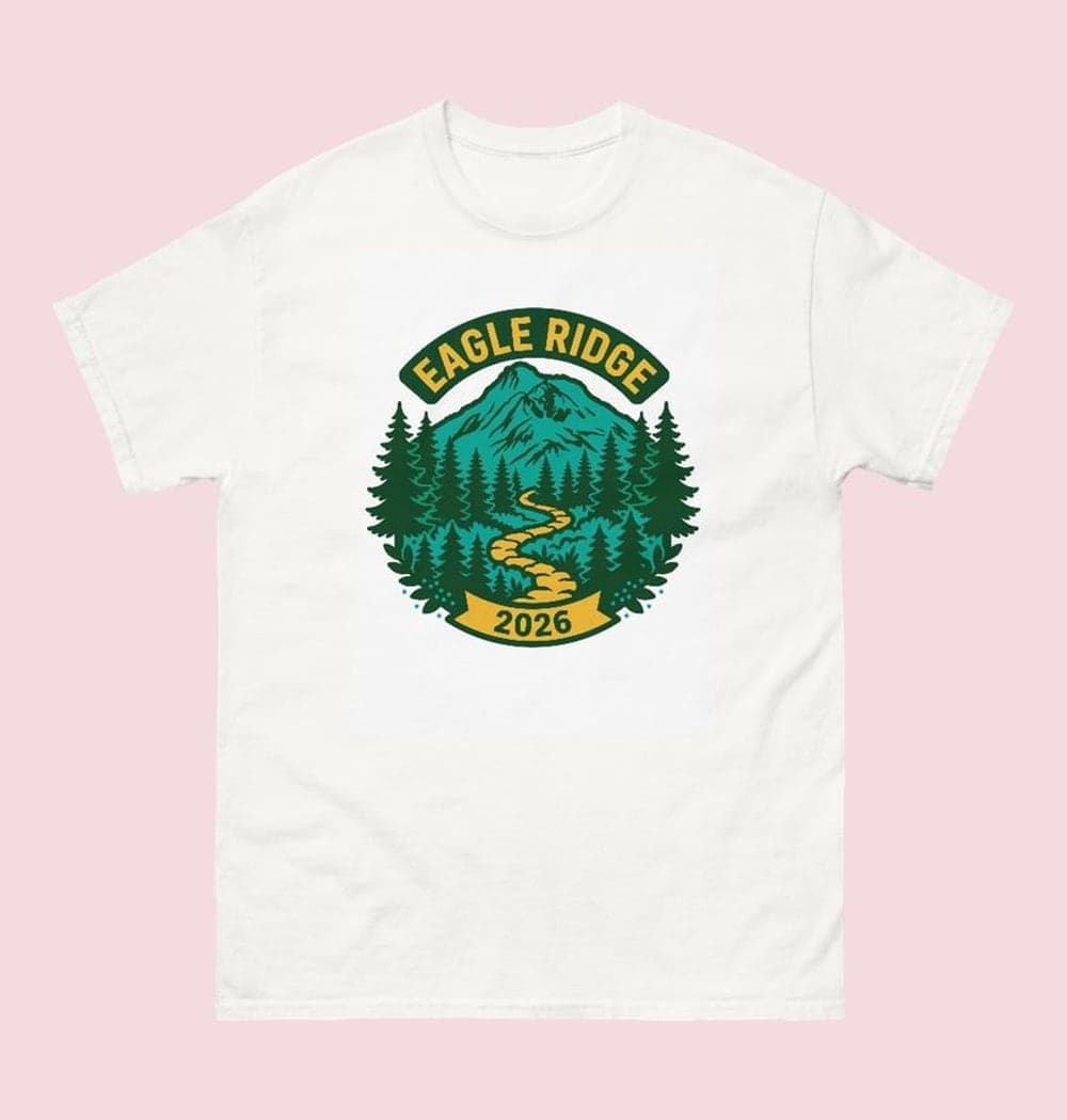 An original national-park-inspired badge of the chosen landscape, with mountains, desert, forest, or coast as specified, on a t-shirt (example made with AI)