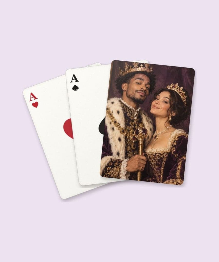 A playing card with a royal couple portrait on its back, over a face card (example)