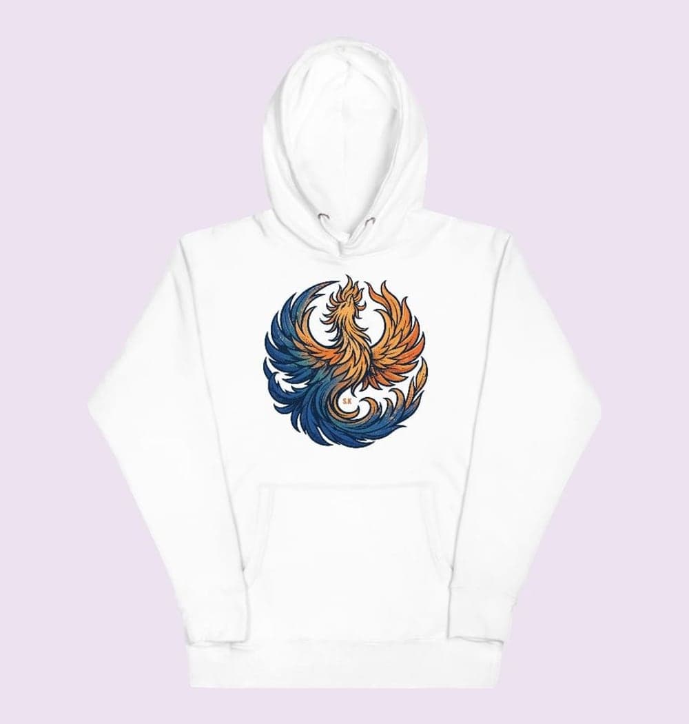 An original phoenix rising in a graceful circular composition, with feathers shifting from deep blue to warm orange, on a hoodie (example made with AI)