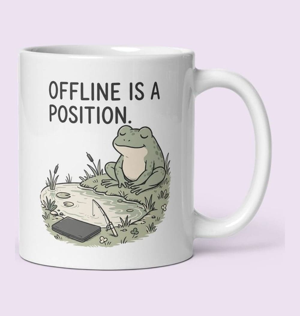 An original relaxed frog sitting beside a pond, with a closed laptop and a tiny fishing rod, on a mug (example made with AI)