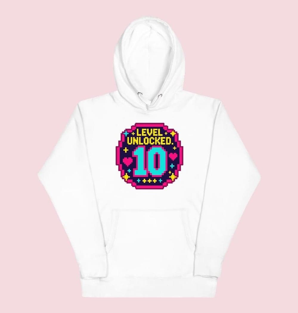 An original arcade-style birthday emblem with the supplied age as a large central number and the words “LEVEL UNLOCKED.” Add small stars, hearts, and geometric sparkles, on a hoodie (example made with AI)